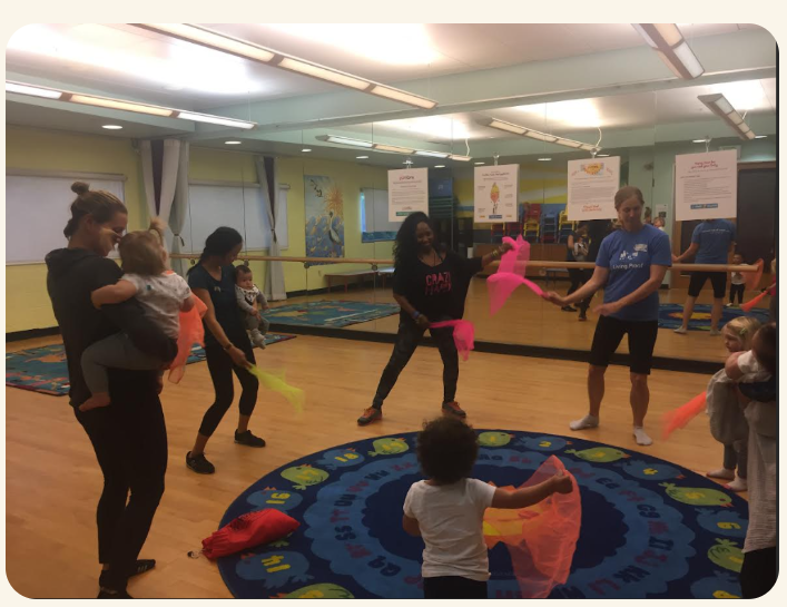 Monica teaching a movement class with children and families